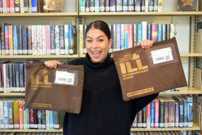 Librarian Holding Packages