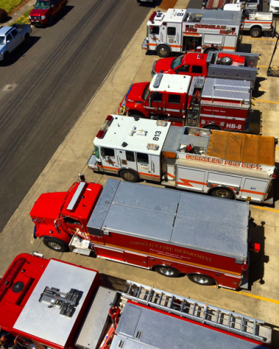 Fire apparatus lined up outside fire station. 